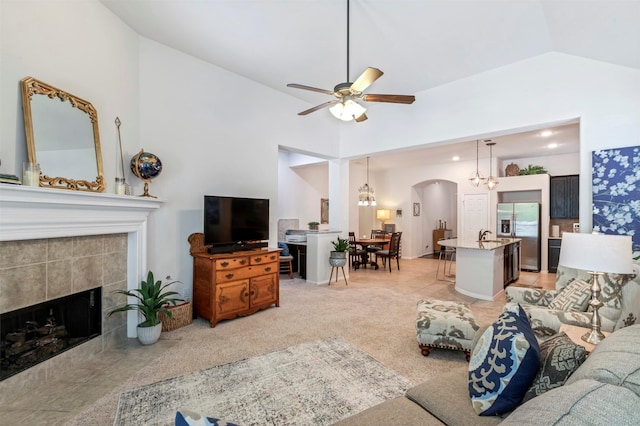 17219 Rookery Ct, Conroe, TX 77385 - living area featuring lofted ceiling, arched walkways, ceiling fan, and a tile fireplace