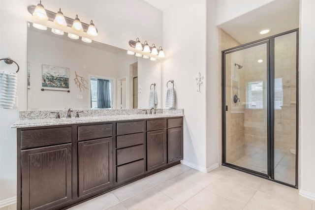 17219 Rookery Ct, Conroe, TX 77385 - full bathroom featuring a stall shower, double vanity, tile patterned flooring, and baseboards