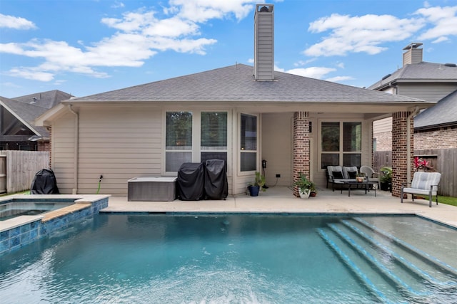 17219 Rookery Ct, Conroe, TX 77385 - rear view of house with fence, a patio area, a pool with connected hot tub, a chimney, and roof with shingles