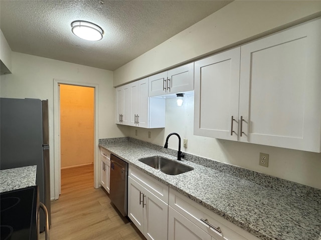 7400 Bellerive Dr Unit 1004, Houston, TX 77036 - kitchen featuring a sink, dishwasher, a textured ceiling, light wood-type flooring, and white cabinetry