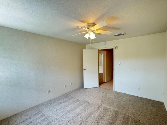 7400 Bellerive Dr Unit 1004, Houston, TX 77036 - unfurnished room featuring light carpet, a ceiling fan, and a textured ceiling