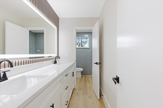 2506 Swan Ct, Houston, TX 77058 - bathroom with toilet, double vanity, and wood finished floors