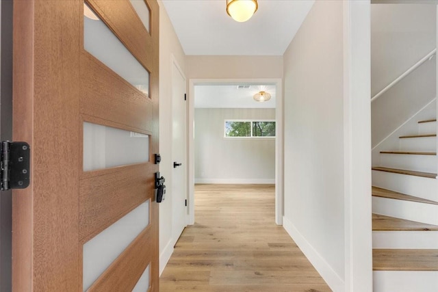 2506 Swan Ct, Houston, TX 77058 - hallway with light wood-style flooring, stairway, and baseboards