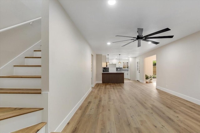 2506 Swan Ct, Houston, TX 77058 - unfurnished living room featuring a ceiling fan, light wood-type flooring, recessed lighting, baseboards, and stairway