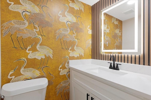 2506 Swan Ct, Houston, TX 77058 - bathroom featuring wallpapered walls, vanity, and toilet