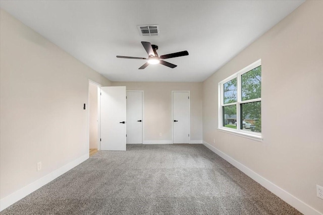 unfurnished bedroom featuring carpet, baseboards, and a ceiling fan