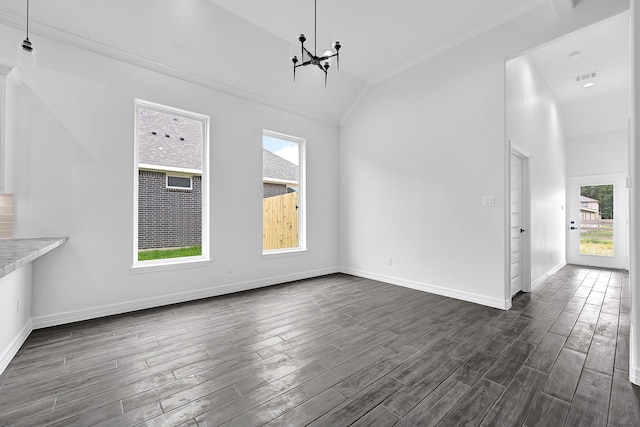 201 Big Spring Dr, Anahuac, TX 77514 - unfurnished dining area featuring vaulted ceiling, dark wood-style floors, a chandelier, healthy amount of natural light, and baseboards