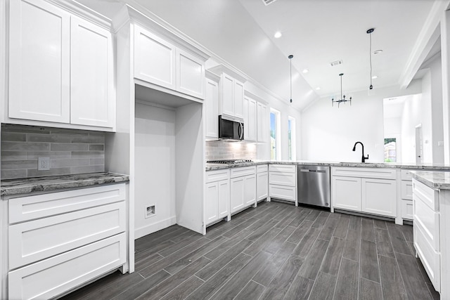 201 Big Spring Dr, Anahuac, TX 77514 - kitchen featuring stainless steel appliances, a sink, white cabinetry, recessed lighting, and vaulted ceiling