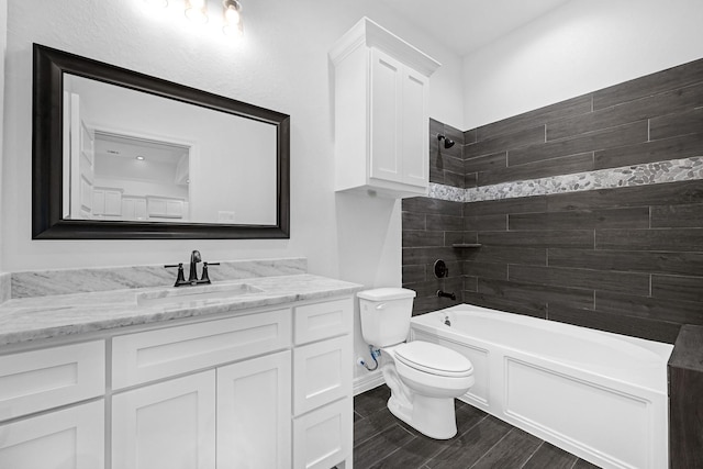201 Big Spring Dr, Anahuac, TX 77514 - bathroom with toilet, vanity, wood finished floors, and shower / tub combination