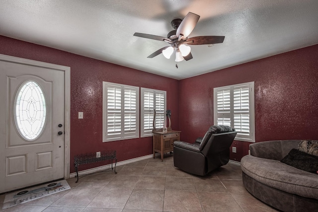 21309 W Memorial Dr, Porter, TX 77365 - tiled entryway featuring a textured wall, ceiling fan, baseboards, and a textured ceiling