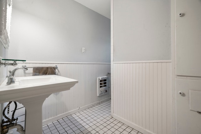 815 Iwo St, Alvin, TX 77511 - bathroom featuring heating unit, a wainscoted wall, tile patterned floors, baseboards, and a sink