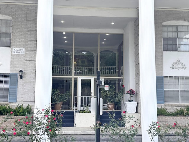 view of exterior entry with brick siding
