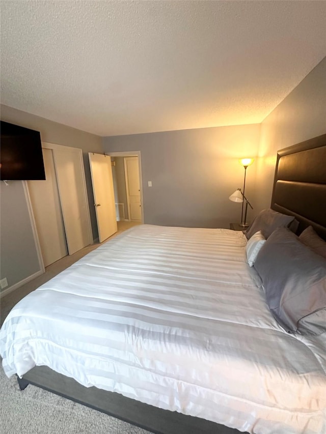 carpeted bedroom featuring a textured ceiling