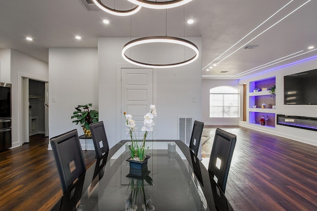 dining space with wood finished floors, baseboards, and recessed lighting