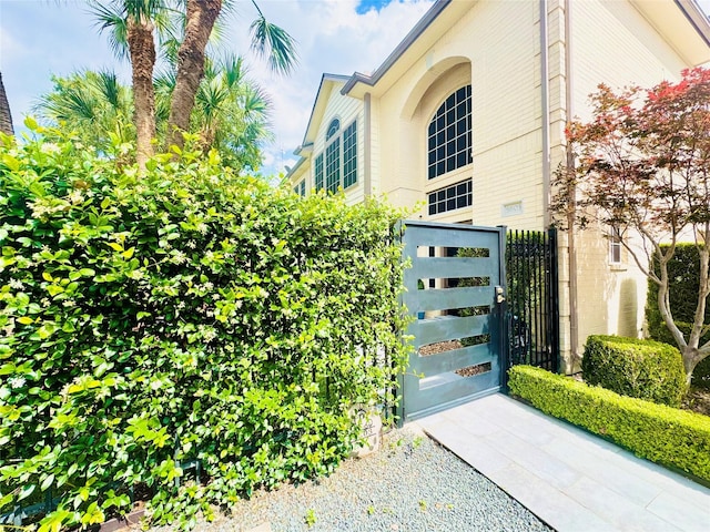 view of home's exterior featuring a gate and fence