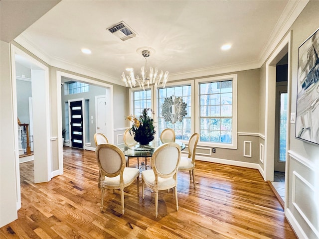 dining space featuring a chandelier, crown molding, light wood finished floors, baseboards, and recessed lighting