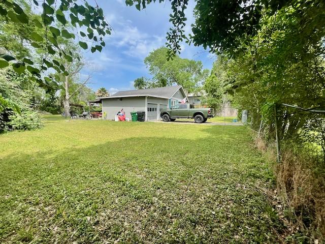 1227 W 25th St, Houston, TX 77008 - view of yard featuring an attached garage