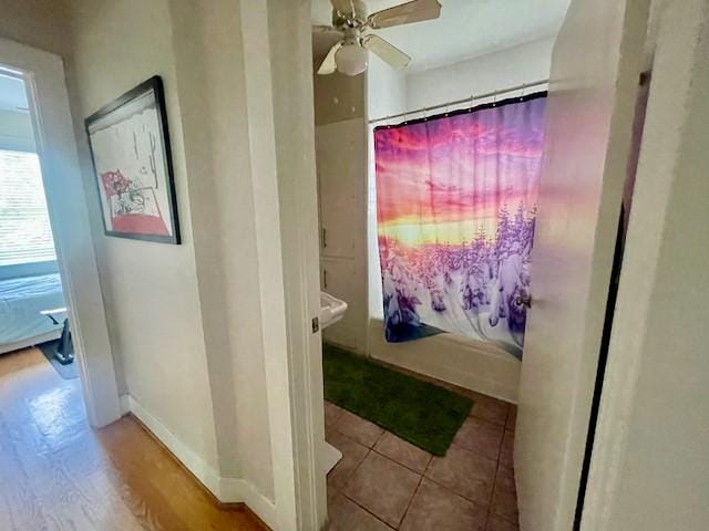 1227 W 25th St, Houston, TX 77008 - bathroom featuring a ceiling fan, shower / bathtub combination with curtain, baseboards, and tile patterned floors