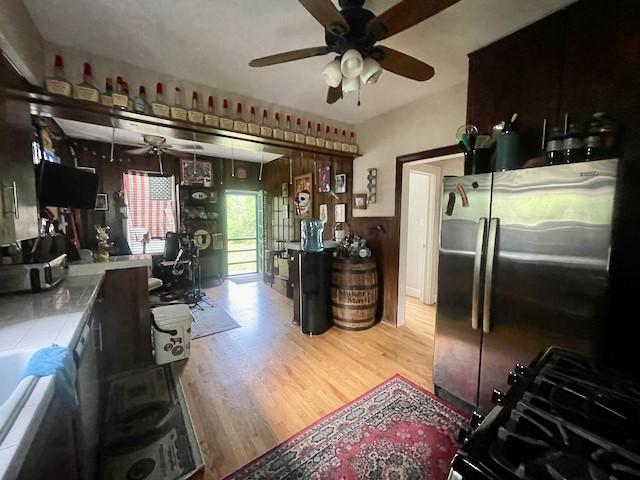 1227 W 25th St, Houston, TX 77008 - kitchen featuring freestanding refrigerator, a ceiling fan, and light wood-type flooring