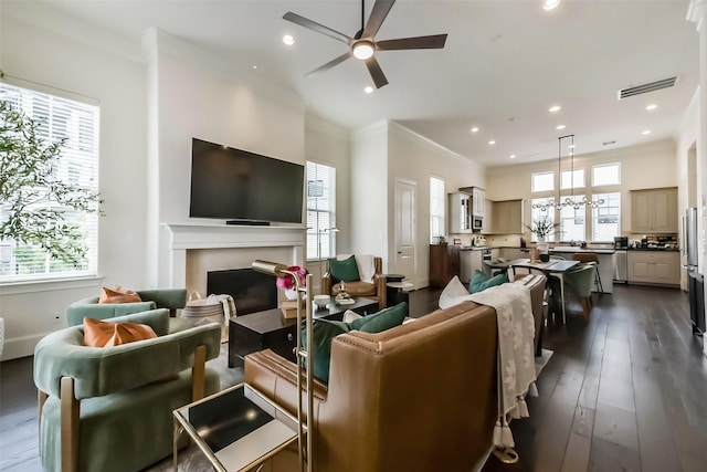9450 London Bridge Sta, Houston, TX 77045 - living room featuring a ceiling fan, recessed lighting, a fireplace, dark wood finished floors, and crown molding