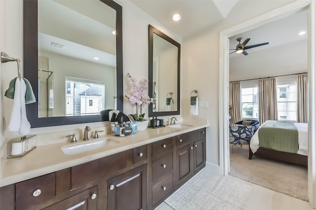 9450 London Bridge Sta, Houston, TX 77045 - ensuite bathroom with ceiling fan, recessed lighting, double vanity, and baseboards