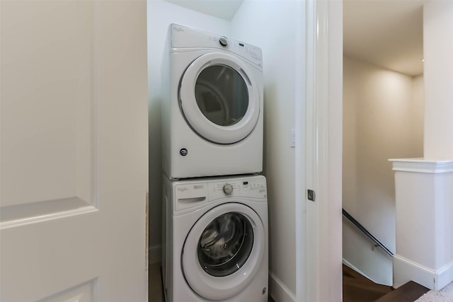 9450 London Bridge Sta, Houston, TX 77045 - laundry room featuring stacked washer / dryer, wood finished floors, and baseboards