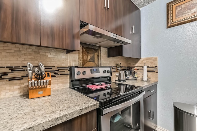11427 Sageglen Dr, Houston, TX 77089 - kitchen featuring stainless steel range with electric stovetop, ventilation hood, backsplash, light countertops, and a textured wall