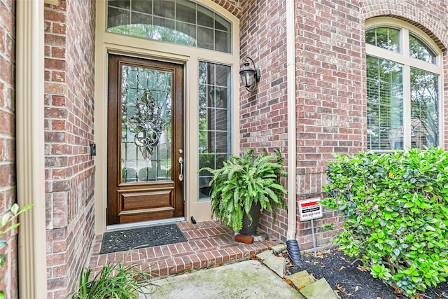 property entrance featuring brick siding