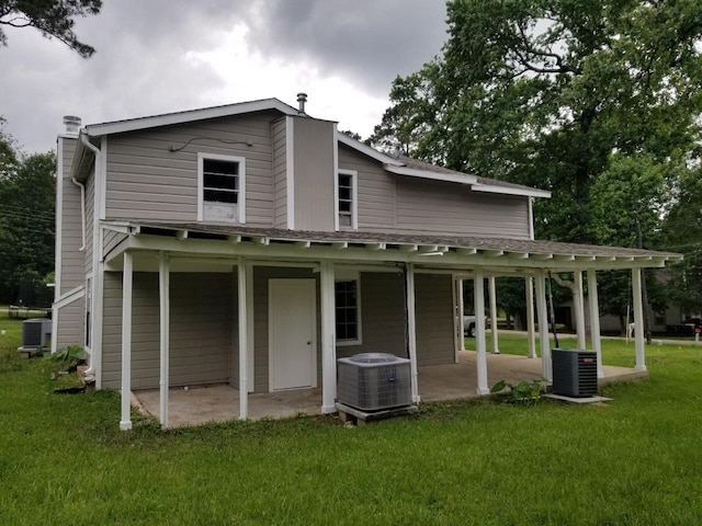 1305 Saint Lawrence River Rd, Conroe, TX 77316 - rear view of house with central air condition unit, a patio, and a yard