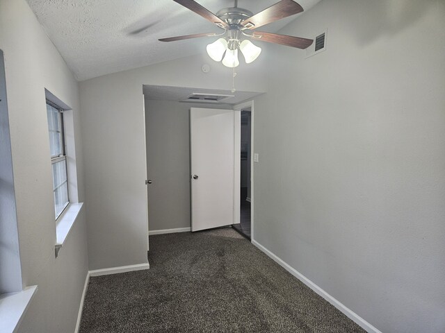 1305 Saint Lawrence River Rd, Conroe, TX 77316 - unfurnished bedroom featuring dark carpet, lofted ceiling, baseboards, a ceiling fan, and a textured ceiling