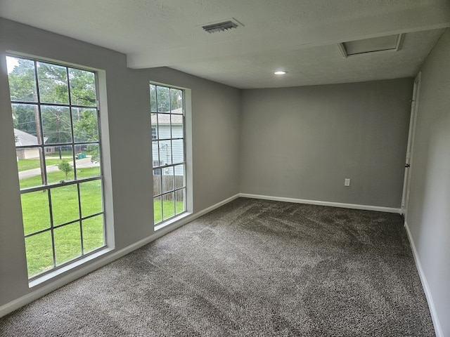 1305 Saint Lawrence River Rd, Conroe, TX 77316 - unfurnished room featuring dark carpet, baseboards, and attic access