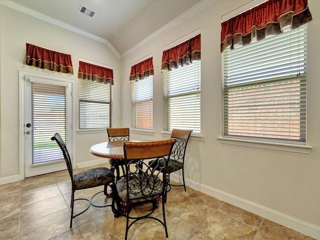 tiled dining room featuring ornamental molding and baseboards