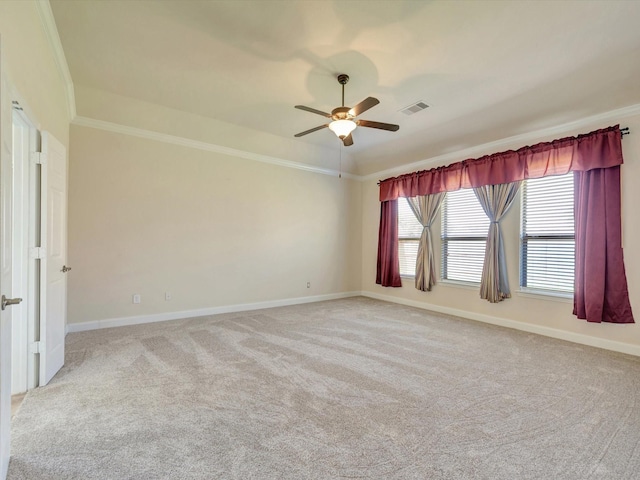 unfurnished room with ornamental molding, light carpet, baseboards, and ceiling fan