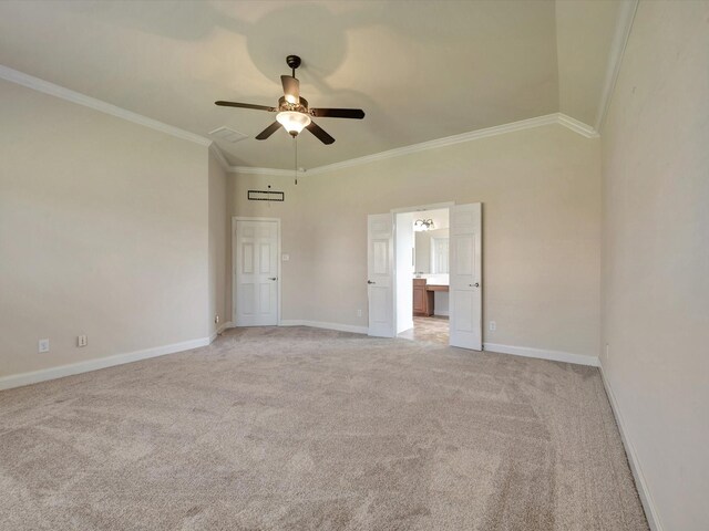 empty room featuring light colored carpet, ceiling fan, baseboards, and ornamental molding