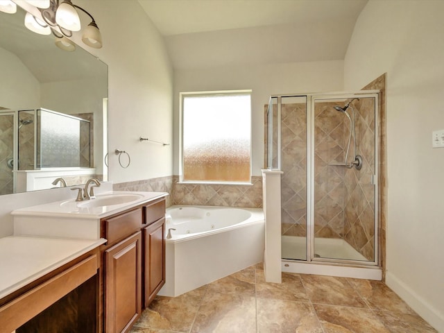 bathroom featuring a stall shower, vanity, a jetted tub, and a chandelier