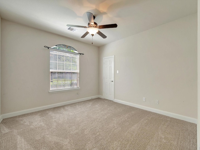 empty room with light carpet, ceiling fan, and baseboards