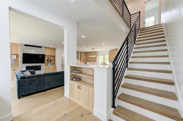 1611 W 22nd St Unit C, Houston, TX 77008 - stairs featuring a large fireplace, wood finished floors, recessed lighting, and built in shelves