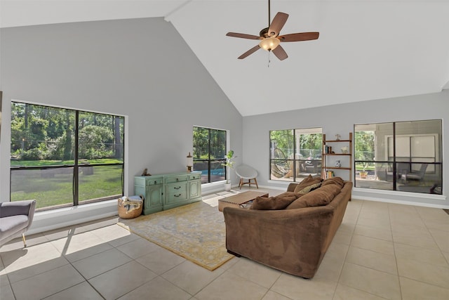 living room featuring high vaulted ceiling, tile patterned flooring, healthy amount of natural light, and a ceiling fan