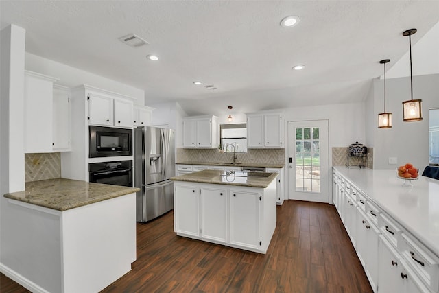 kitchen featuring black appliances, white cabinetry, backsplash, and recessed lighting