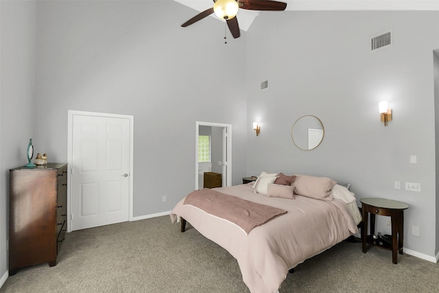 bedroom with light carpet, a towering ceiling, baseboards, and a ceiling fan