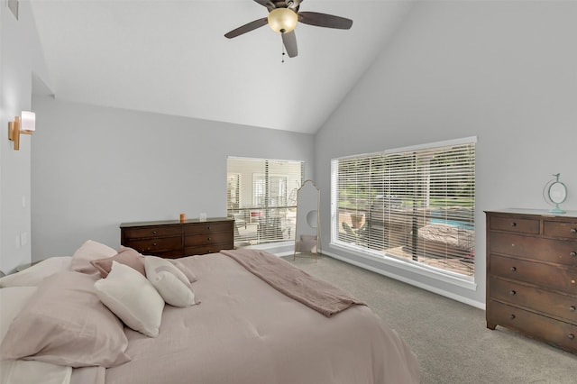 carpeted bedroom with high vaulted ceiling, baseboards, and a ceiling fan