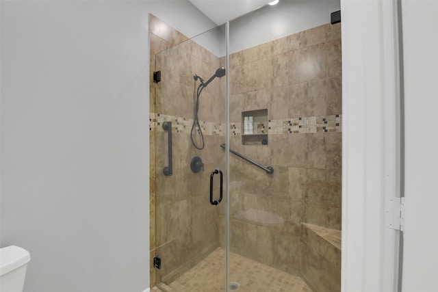 bathroom with toilet and a shower stall
