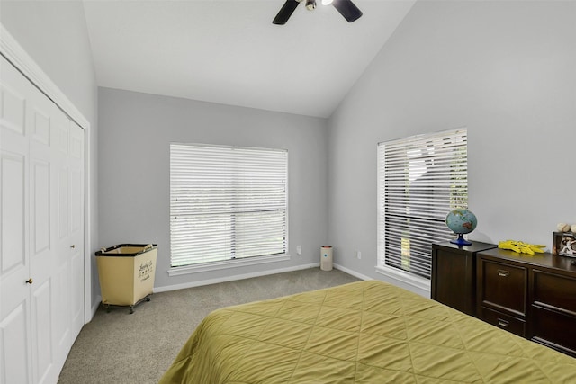 bedroom featuring lofted ceiling, carpet, a closet, ceiling fan, and baseboards