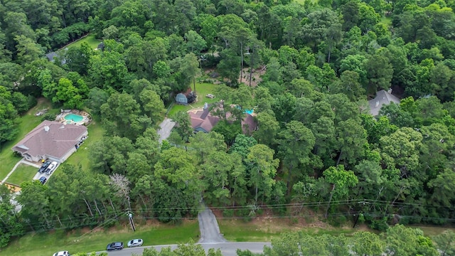 view of property location featuring a forest