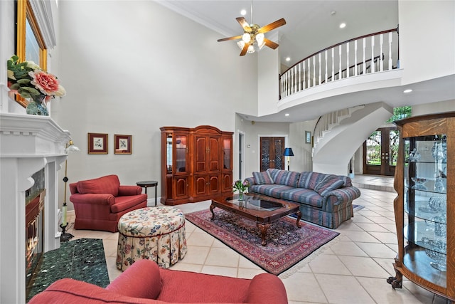 19827 Timberwind Ln, Houston, TX 77094 - living room with a fireplace, a towering ceiling, stairs, tile patterned flooring, and ceiling fan