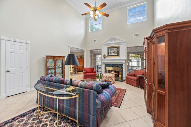 19827 Timberwind Ln, Houston, TX 77094 - living room with ornamental molding, a ceiling fan, light tile patterned flooring, a high ceiling, and a premium fireplace