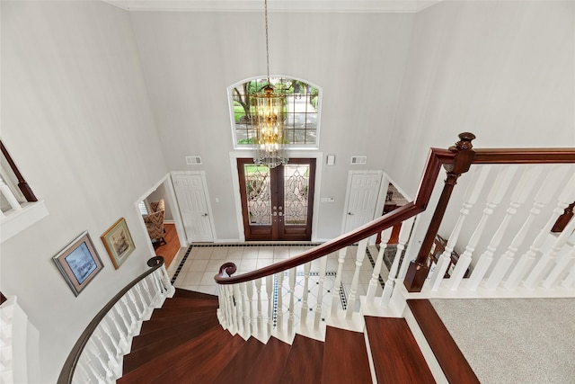 19827 Timberwind Ln, Houston, TX 77094 - entryway with a high ceiling, stairs, a chandelier, tile patterned flooring, and french doors