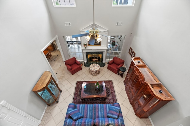 19827 Timberwind Ln, Houston, TX 77094 - living room featuring a high ceiling, tile patterned flooring, a ceiling fan, and a high end fireplace