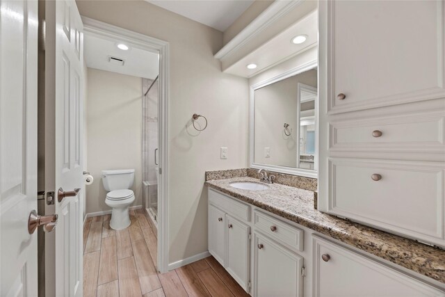 19827 Timberwind Ln, Houston, TX 77094 - full bathroom with a stall shower, vanity, toilet, wood finished floors, and baseboards