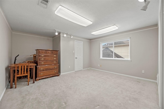 19827 Timberwind Ln, Houston, TX 77094 - bedroom with rail lighting, a textured ceiling, carpet, and baseboards